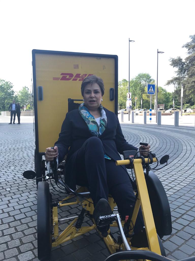 UN Climate Change Executive Secretary Patricia Espinosa tests a new DHL's zero-emission postal vehicle