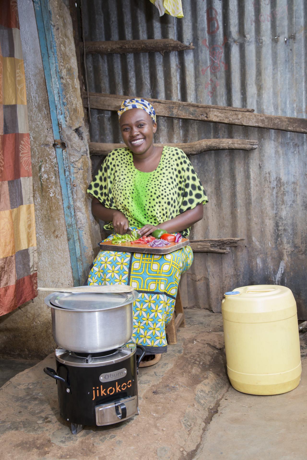 Picture of a woman cooking with a clean cooking stove in Africa - UN Climate Action Blog