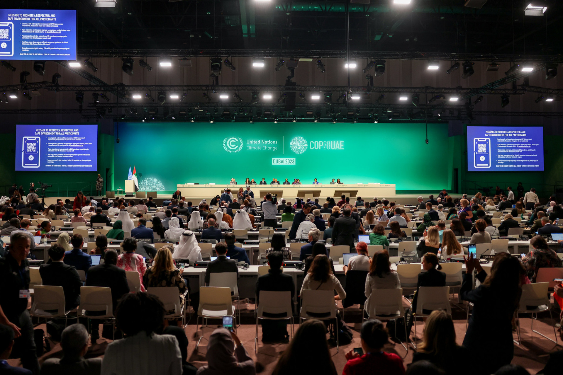 Delegates gather in a large plenary room at COP28