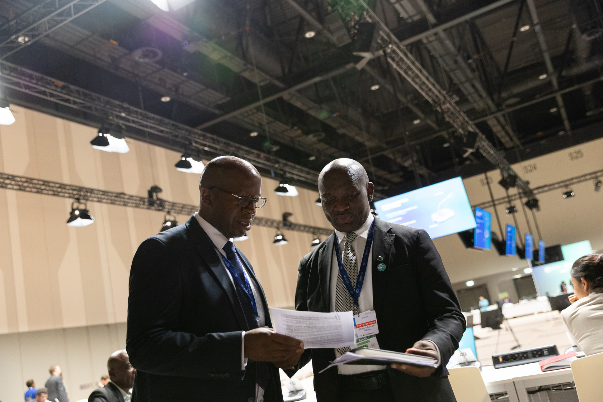 Two delegates at COP28 discuss text