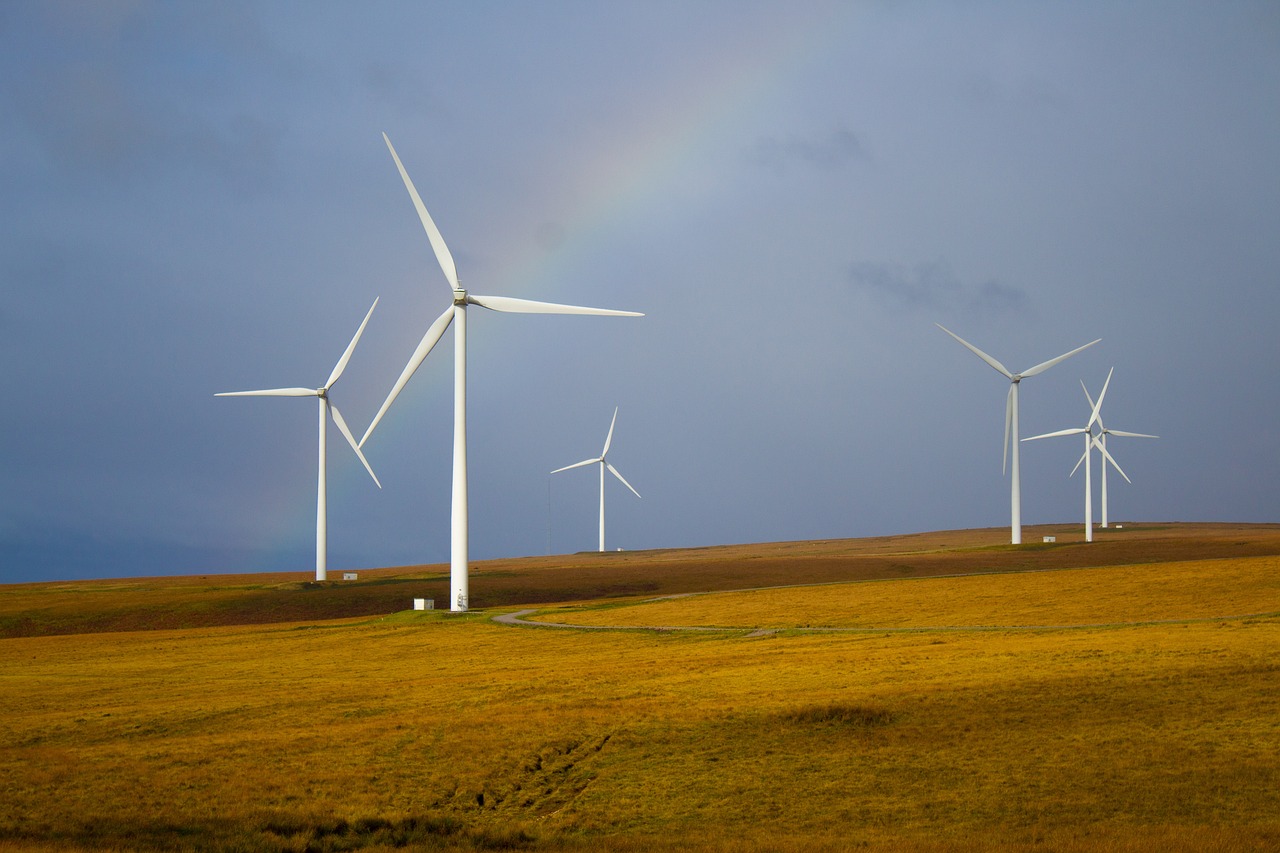 Windmills framed by a rainbow.
