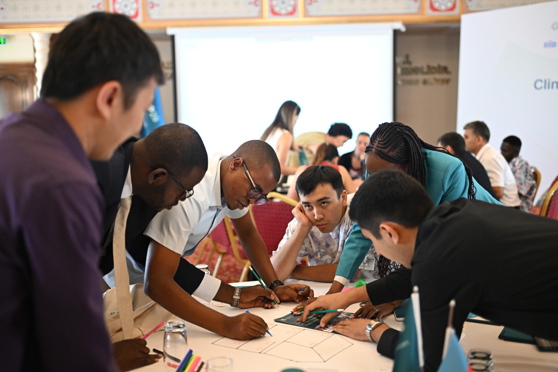 Young people working around a table to address climate change