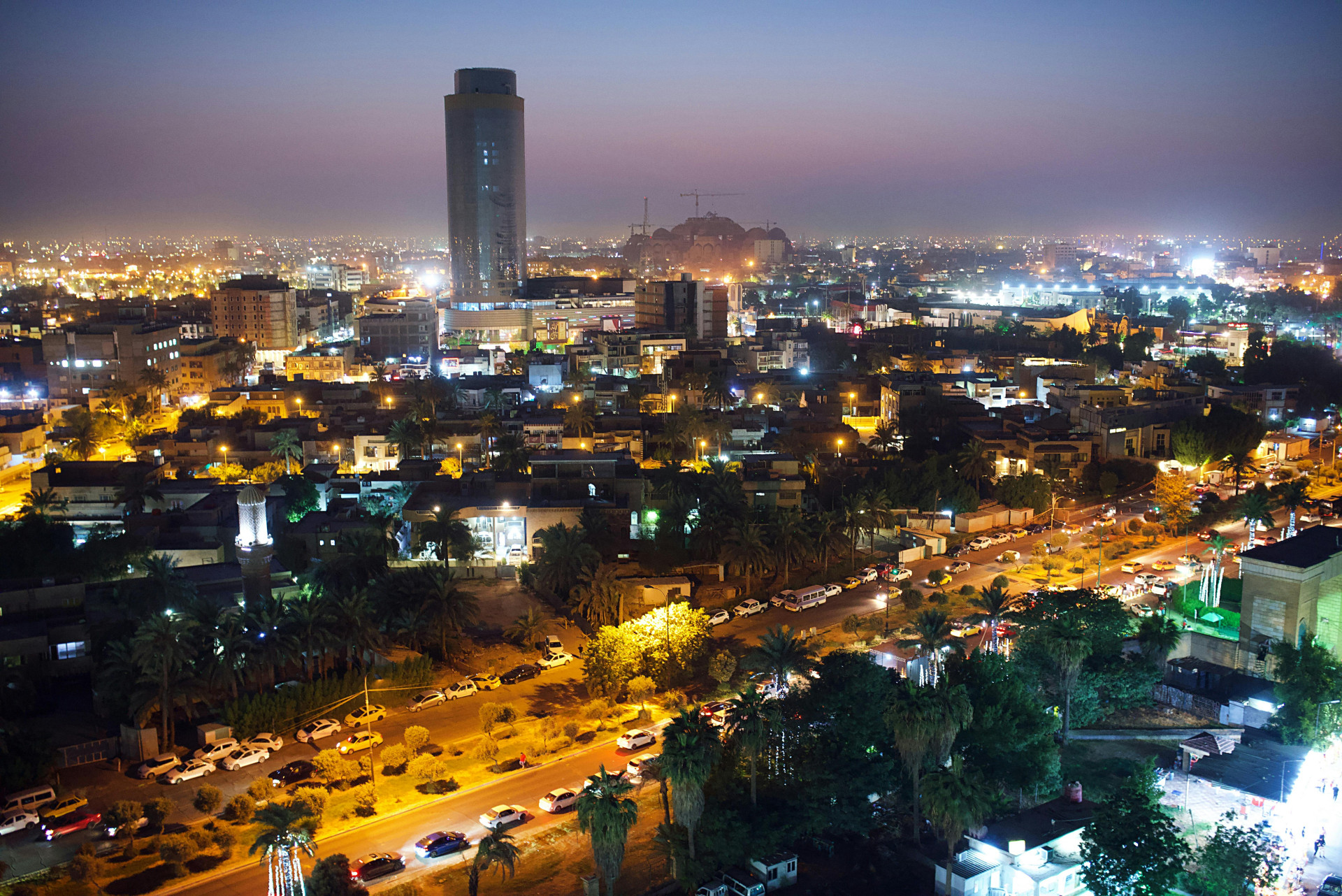 An Aerial Photography of Cars Parked on Road Near the Buildings at Night in Baghdad, Iraq