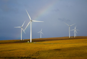 Windmills framed by a rainbow.