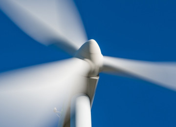 Wind turbine against blue sky