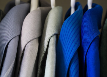 A rack of gorgeous sweaters hangs artfully.