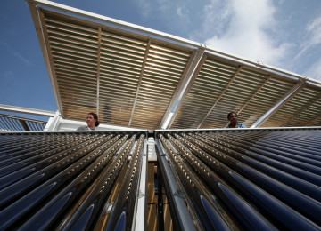 Brianna Bacon, right, and Lizzie DeLeonibus, left, of Maryland look out over Florida International University's solar thermal collector system at West Potomac Park in Washington, D.C