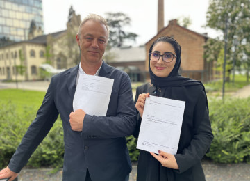 Maria AlJishi (right) and Martin Hession (left), Chair and Vice Chair of the Article 6.4 Supervisory Body, hold the text that was agreed, which introduces the Appeals and Grievances Procedure.