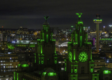 The City of Liverpool lit up in green lights at night