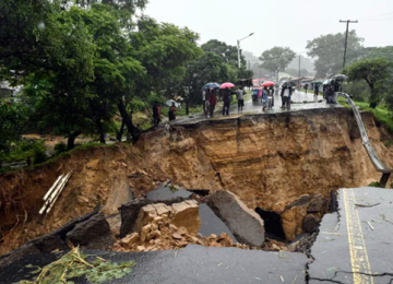 A road connecting the cities of Blantyre and Lilongwe is seen damaged in Malawi following heavy rains caused by Tropical Cyclone Freddy in 2023.
