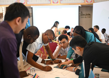 Young people working around a table to address climate change