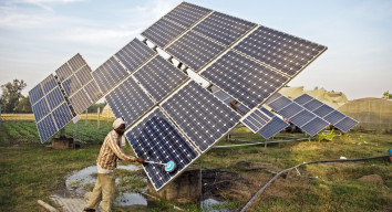 A man cleans a solar panel. 