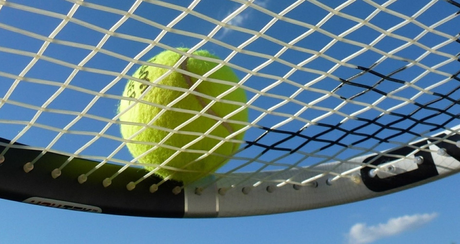 Tennis ball on raquet