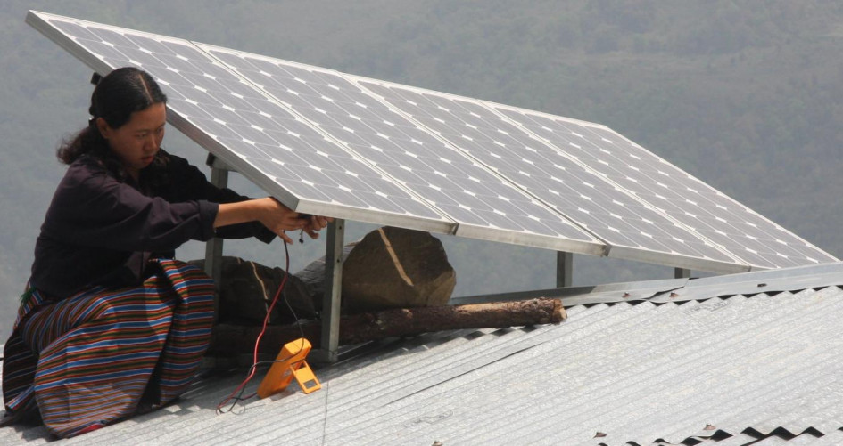 Woman mounting rooftop solar panels