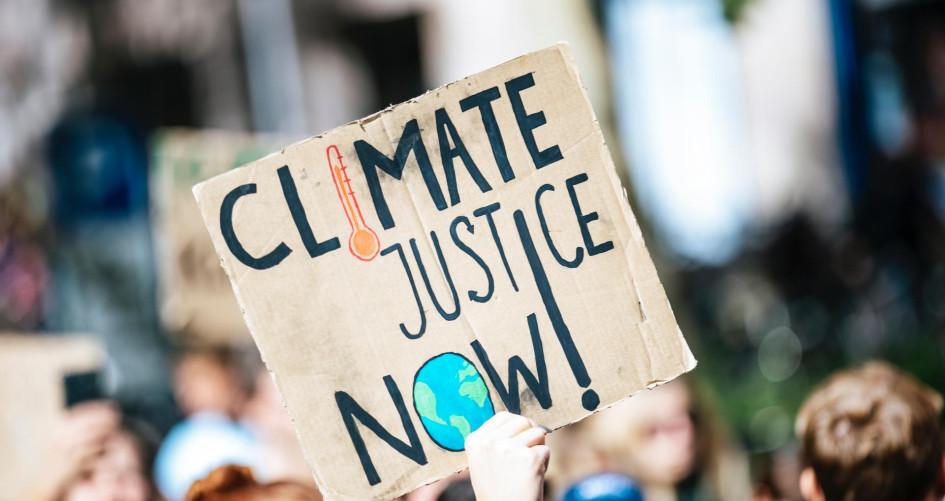 People gathering outside building for Climate Justice Now protest
