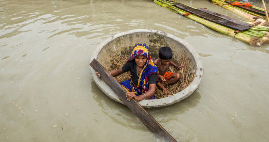 Woman and child in makeshift boat during flooding