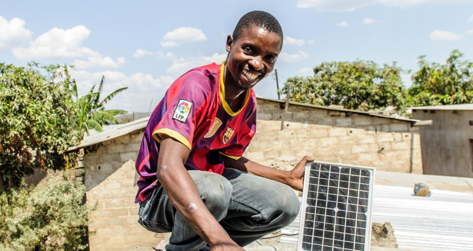 Boy with solar panel Africa
