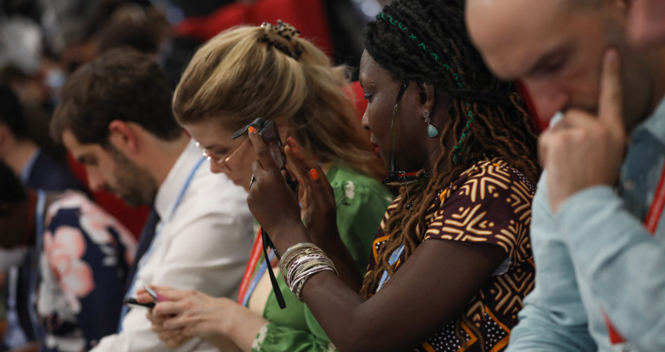 Delegates at COP27 listen intently to speakers talking about global climate action.