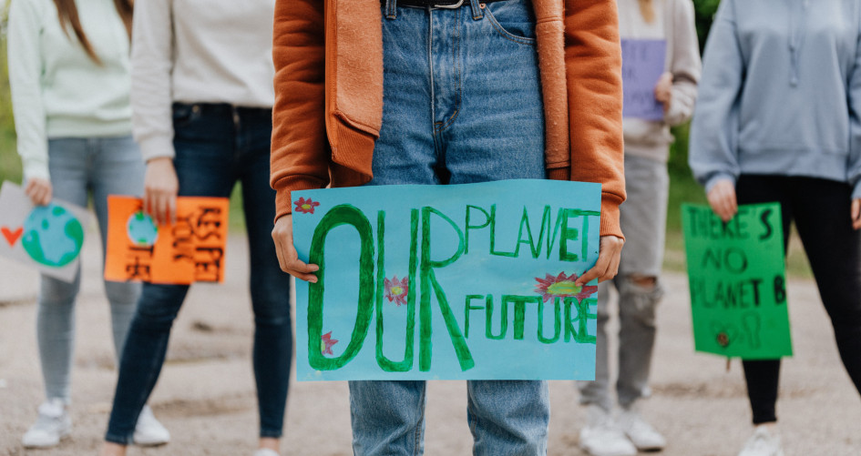 Children holding sign that says Our Planet Our Future