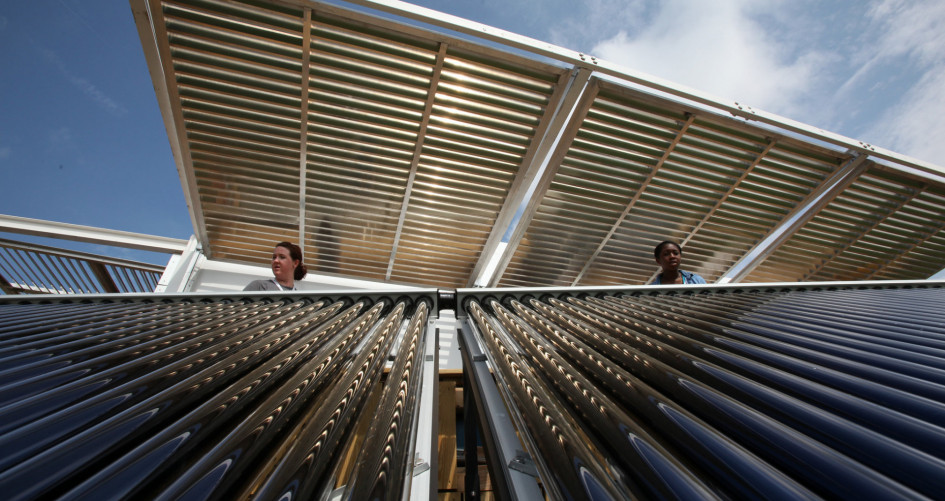 Brianna Bacon, right, and Lizzie DeLeonibus, left, of Maryland look out over Florida International University's solar thermal collector system at West Potomac Park in Washington, D.C