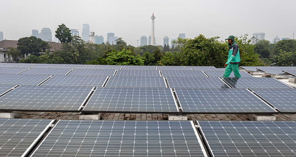 A worker walks around a solar panel system on the rooftop of Istiqlal Mosque area in Jakarta, Indonesia, on November 10, 2023. 