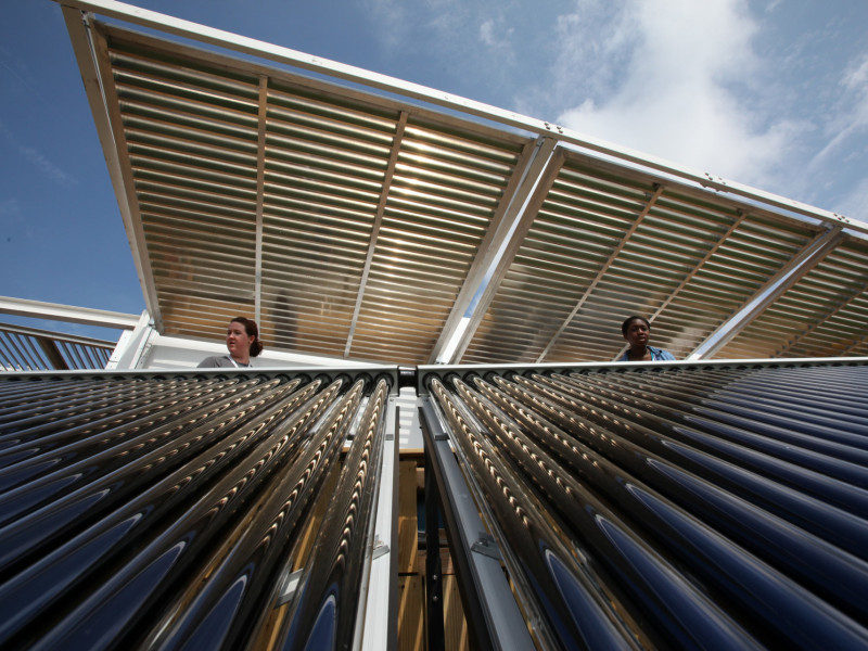 Two workers look at a beautiful solar panel.
