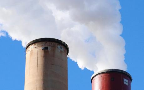 Smoking chimneys against blue sky