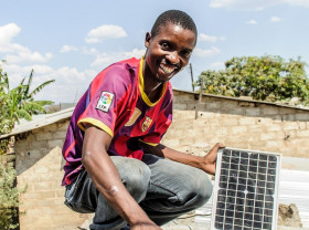 Boy with solar panel Africa