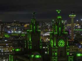 The City of Liverpool lit up in green lights at night