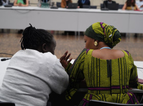 Two participants talk during the June Climate Meetings 2024 in Bonn.