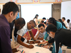 Young people working around a table to address climate change